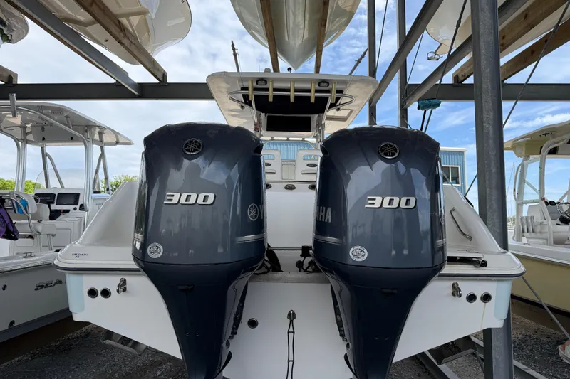 Slide: The Image of 2004 Boston Whaler 320 Outrage with twin Yamaha 300 engines in a boatyard. - 6