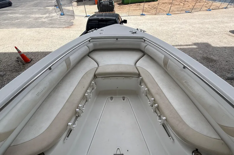 Slide: The Image of 2004 Boston Whaler 320 Outrage boat interior with cushioned seating and spacious deck. - 9