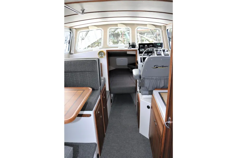 Slide: The Image of Interior of 2026 SeaSport Aleutian 2600 boat, featuring seating and helm area. - 15