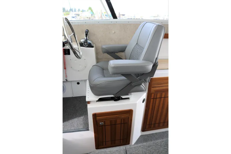 Slide: The Image of Captain's seat in 2026 SeaSport Aleutian 2600 boat, featuring sleek design and wood accents. - 16