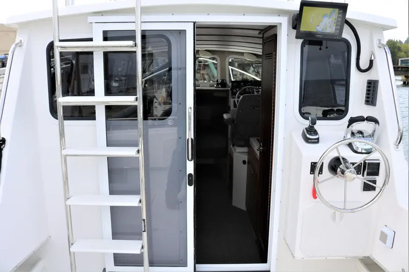 Slide: The Image of 2026 SeaSport Aleutian 2600 boat interior with steering wheel and navigation equipment. - 18
