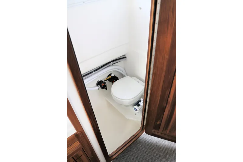 Slide: The Image of 2026 SeaSport Aleutian 2600 boat interior with compact marine toilet. - 21