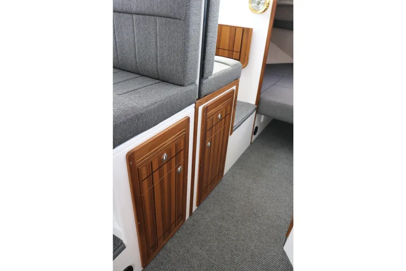 Slide: The Image of Interior of 2026 SeaSport Aleutian 2600, featuring wooden cabinetry and gray upholstery. - 22