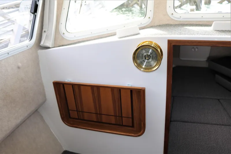 Slide: The Image of Interior of 2026 SeaSport Aleutian 2600 boat with barometer and wooden paneling. - 25
