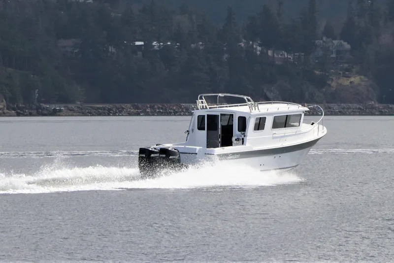 Slide: The Image of 2026 SeaSport Aleutian 2600 cruising on a scenic lake with forested background. - 3