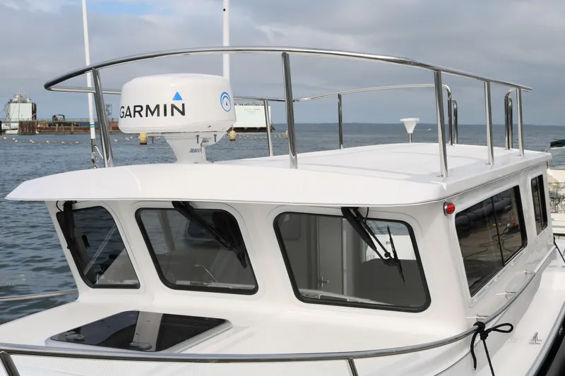 Slide: The Image of 2026 SeaSport Aleutian 2600 boat with Garmin radar, docked by the sea. - 6