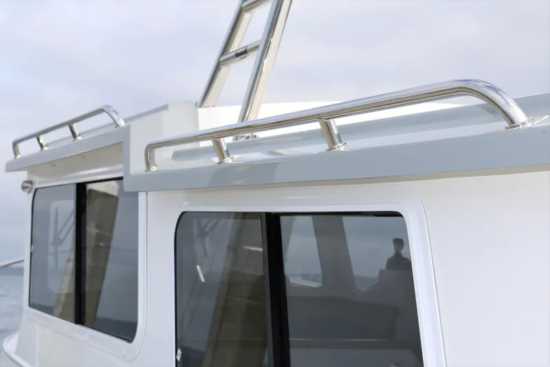 Slide: The Image of 2026 SeaSport Aleutian 2600 boat exterior with sleek windows and stainless steel railings. - 7