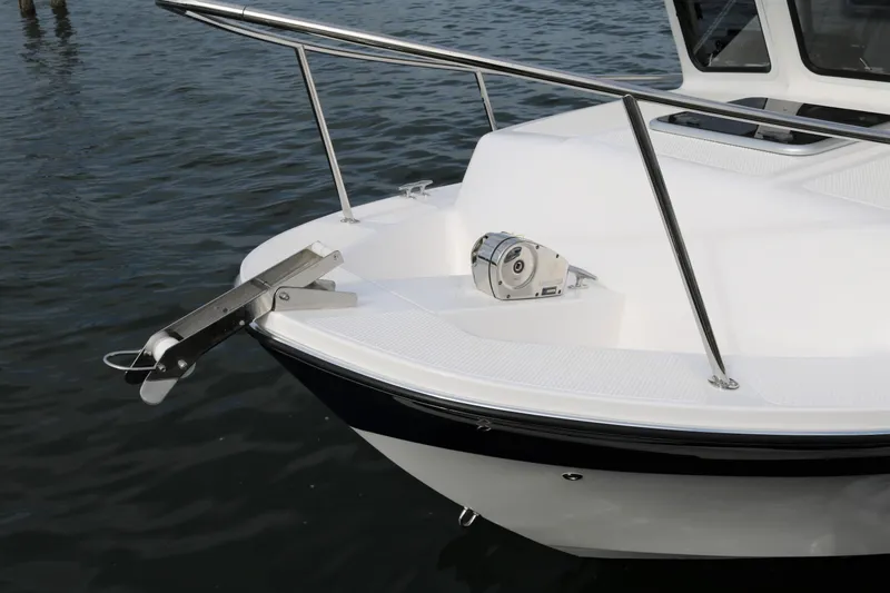 Slide: The Image of 2026 SeaSport Aleutian 2600 boat bow with anchor and railing on water. - 8