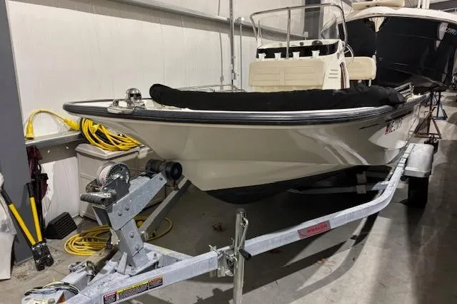 Slide: The Image of 2018 Boston Whaler 150 Montauk boat on trailer in storage facility. - 1