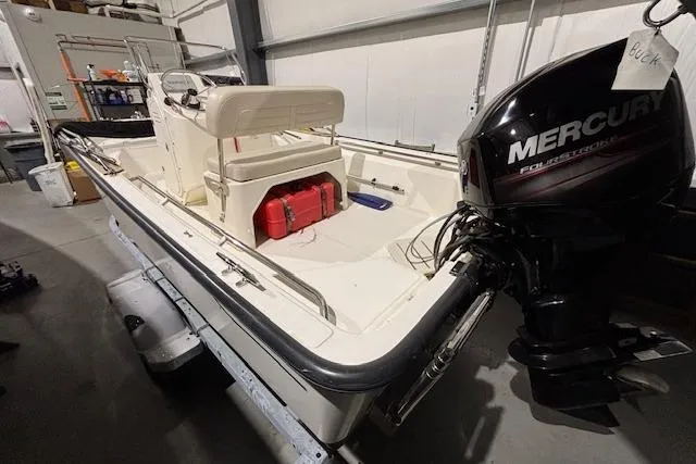 Slide: The Image of 2018 Boston Whaler 150 Montauk boat with Mercury outboard motor in a garage. - 10