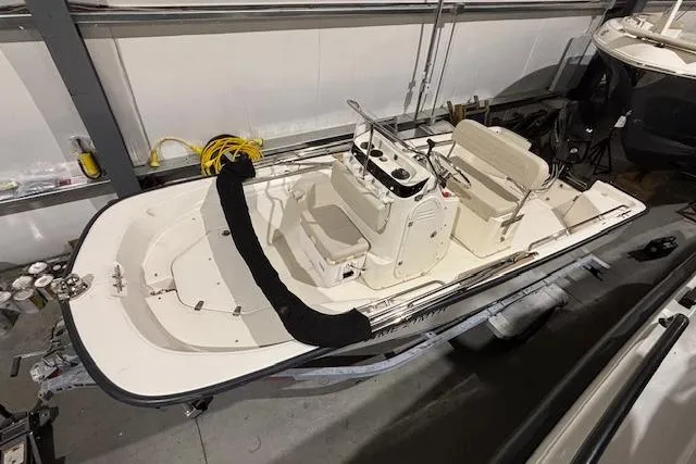 Slide: The Image of 2018 Boston Whaler 150 Montauk boat in indoor storage, top view. - 11