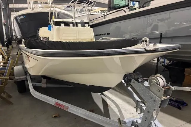 Slide: The Image of 2018 Boston Whaler 150 Montauk boat on trailer in storage facility. - 2