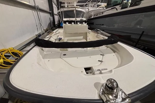 Slide: The Image of 2018 Boston Whaler 150 Montauk boat in indoor storage, showcasing deck and seating area. - 3