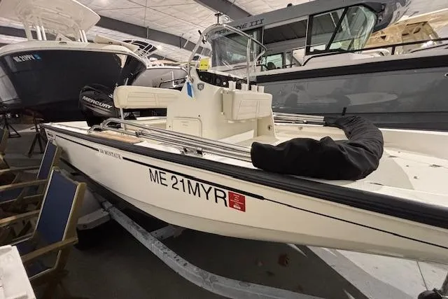 Slide: The Image of 2018 Boston Whaler 150 Montauk boat in storage, side view with registration number ME 21MYR. - 8