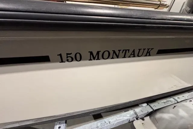 Slide: The Image of 2018 Boston Whaler 150 Montauk boat side view with model name displayed. - 9