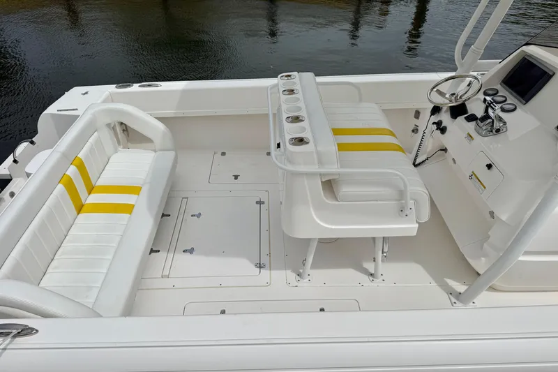 Slide: The Image of 2013 Intrepid 300 Center Console boat interior with white and yellow seating. - 12