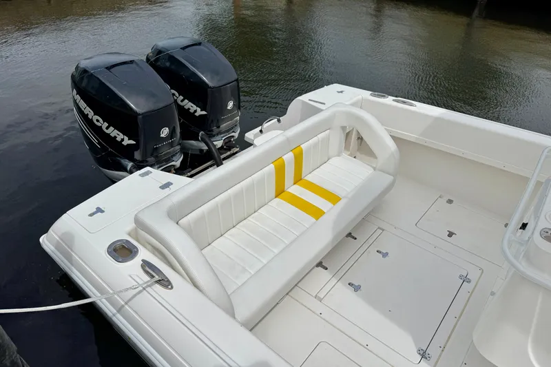 Slide: The Image of 2013 Intrepid 300 Center Console boat with dual Mercury engines and white seating. - 13