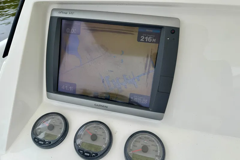 Slide: The Image of Garmin GPS display and gauges on a 2013 Intrepid 300 Center Console boat. - 16