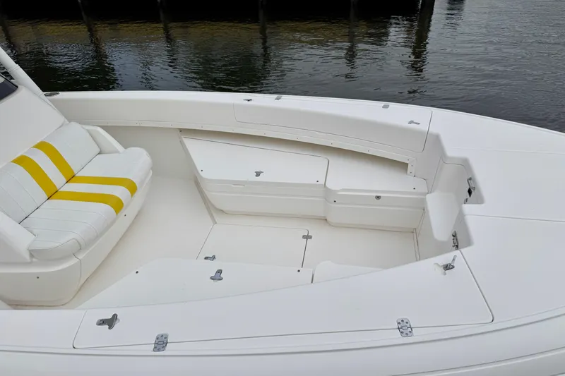 Slide: The Image of 2013 Intrepid 300 Center Console boat interior with white and yellow seating. - 21