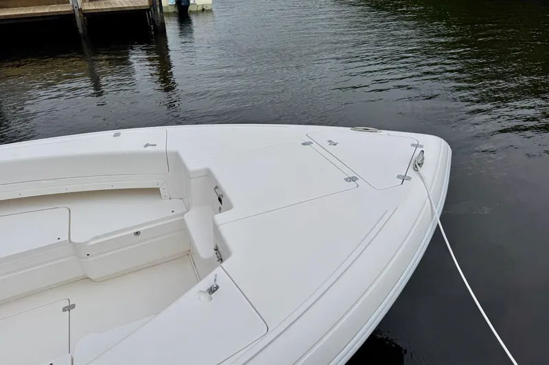 Slide: The Image of 2013 Intrepid 300 Center Console boat docked on calm water. - 22