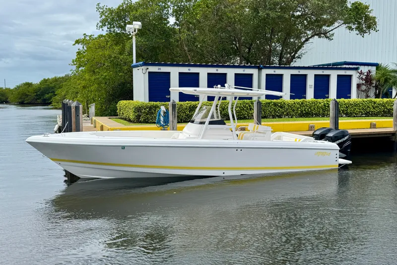 Slide: The Image of 2013 Intrepid 300 Center Console boat docked near storage units. - 3