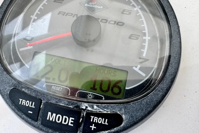 Slide: The Image of Close-up of a 2013 Intrepid 300 Center Console tachometer displaying 106 hours and 12 volts. - 5