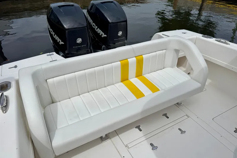 Slide: The Image of 2013 Intrepid 300 Center Console boat with white and yellow seating, dual Mercury engines. - 6