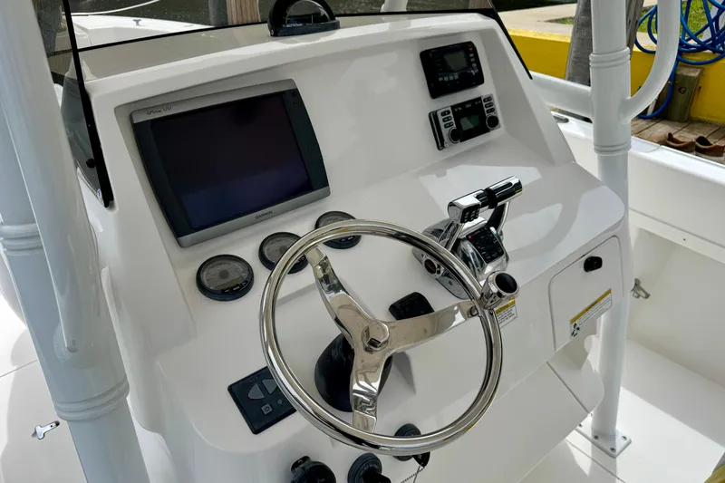 Slide: The Image of 2013 Intrepid 300 Center Console helm with steering wheel and navigation controls. - 9