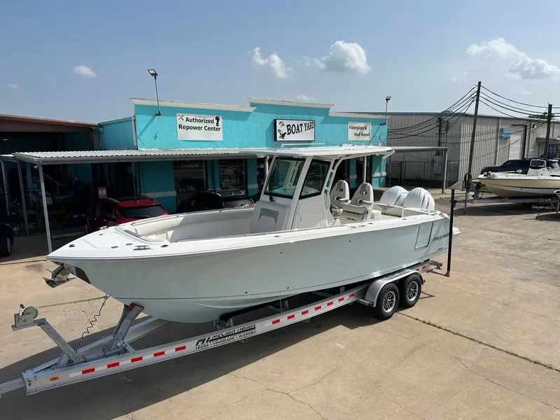 The Image of 2026 Sailfish 272 CC boat on trailer outside workshop. - 1