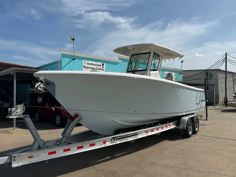 Slide: The Image of 2026 Sailfish 272 CC boat on trailer outside workshop. - 10