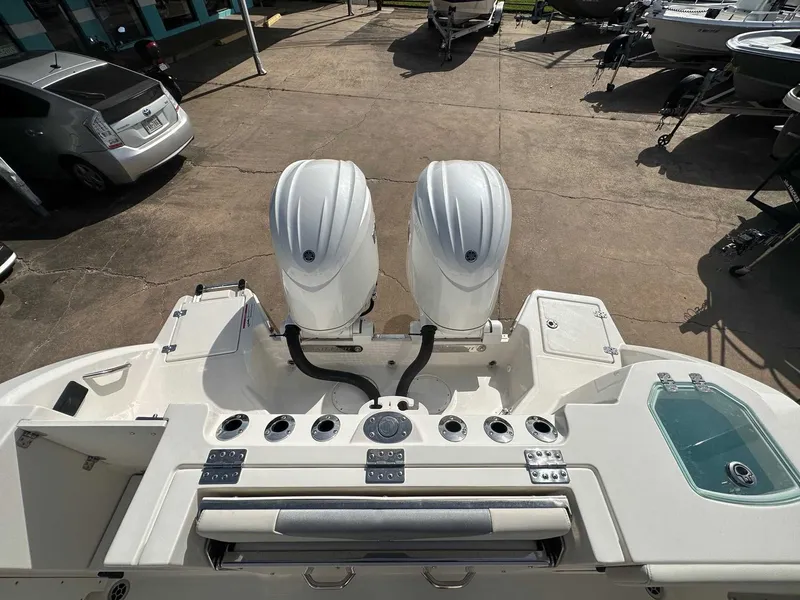 Slide: The Image of Sailfish 272 CC 2026 with dual outboard motors on a parking lot. - 15