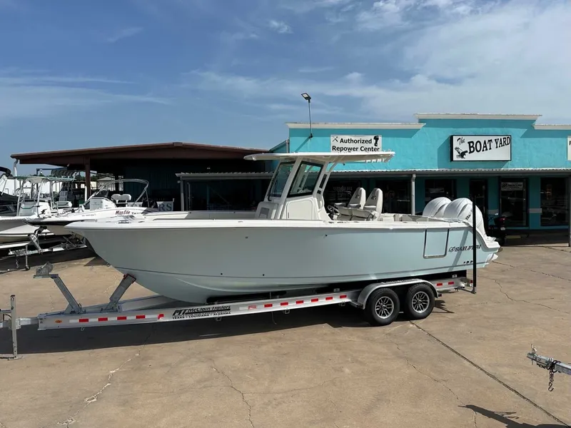Slide: The Image of 2026 Sailfish 272 CC boat on trailer outside boat yard. - 2