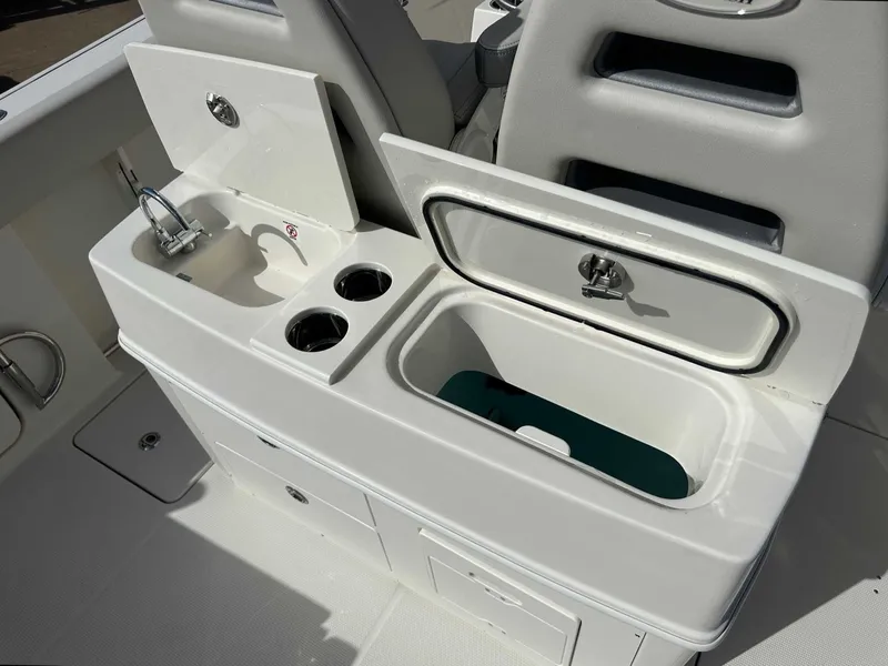 Slide: The Image of Sailfish 272 CC 2026 boat kitchenette with sink and storage. - 21