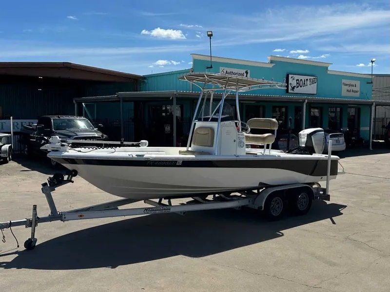 The Image of 2019 NauticStar 227XTS boat on trailer outside workshop. - 1