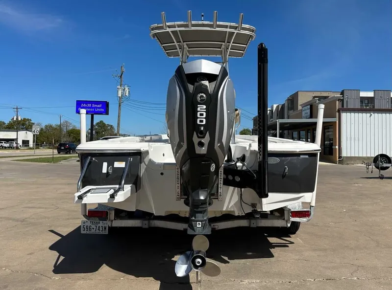 Slide: The Image of Rear view of a 2019 NauticStar 227XTS boat with outboard motor. - 11