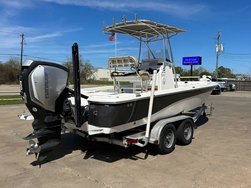 Slide: The Image of 2019 NauticStar 227XTS boat with Evinrude engine on trailer. - 12