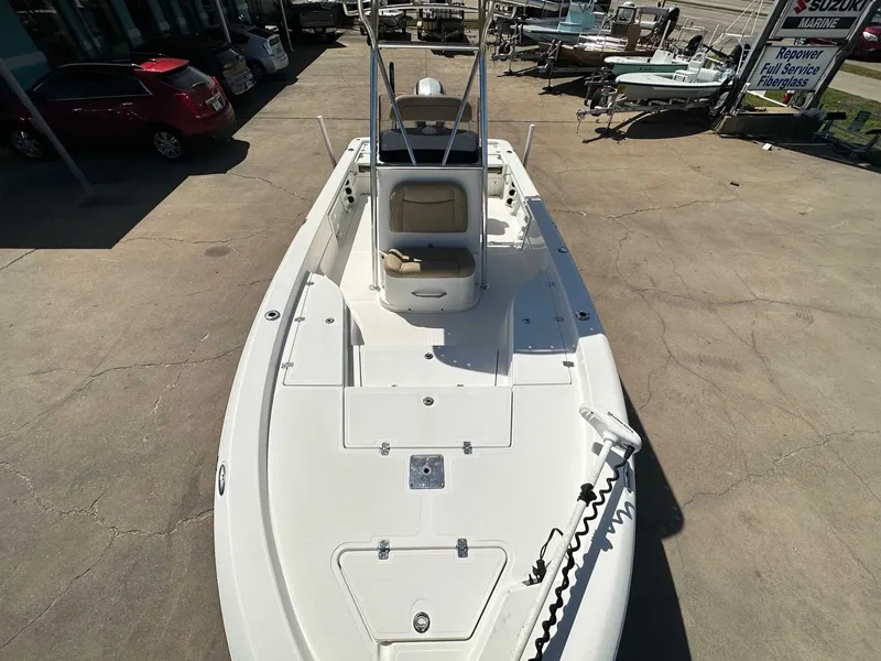 Slide: The Image of 2019 NauticStar 227XTS boat on a parking lot. - 19
