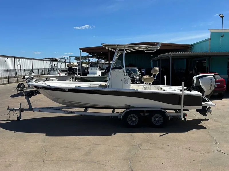 Slide: The Image of 2019 NauticStar 227XTS boat on trailer outdoors. - 2