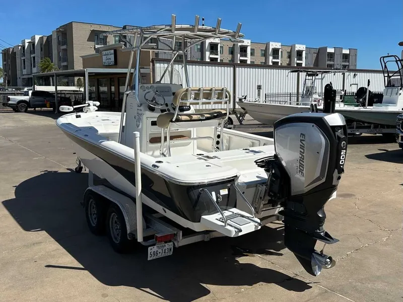 Slide: The Image of 2019 NauticStar 227XTS boat with Evinrude engine on trailer. - 3