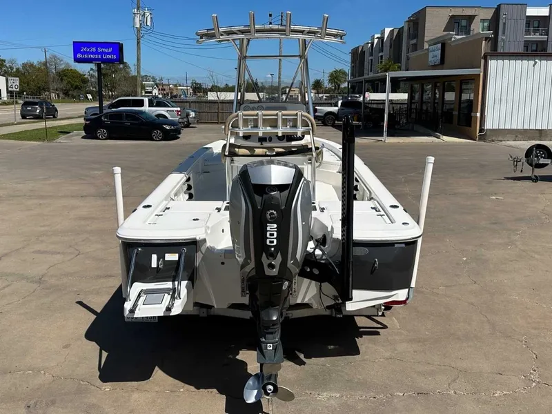 Slide: The Image of Rear view of a 2019 NauticStar 227XTS boat in a parking lot. - 4