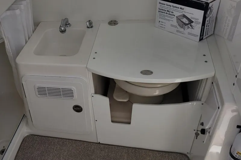 Slide: The Image of 2009 Everglades 350 Center Console boat interior with white seating on a calm waterway. - 16