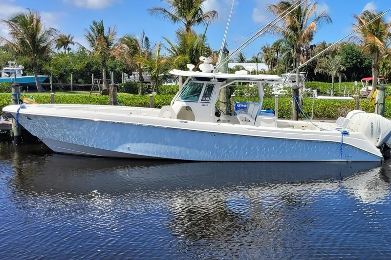 Slide: The Image of 2009 Everglades 350 Center Console boat on calm water under a partly cloudy sky. - 18