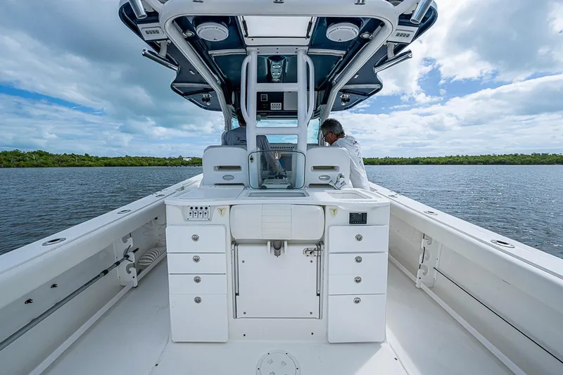 Slide: The Image of 2009 Everglades 350 Center Console boat on calm water under a cloudy sky. - 19