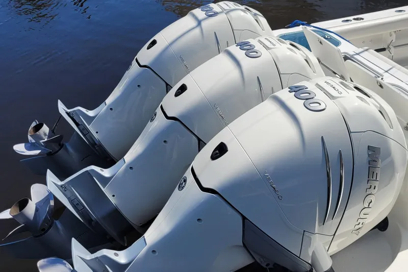 Slide: The Image of 2009 Everglades 350 Center Console boat on calm water under cloudy sky. - 2