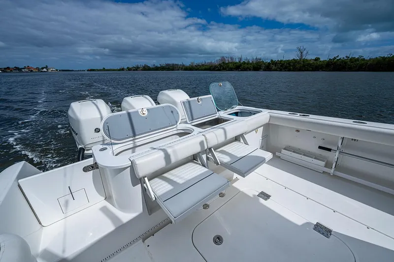Slide: The Image of 2009 Everglades 350 Center Console boat on water, featuring spacious seating and multiple engines. - 21
