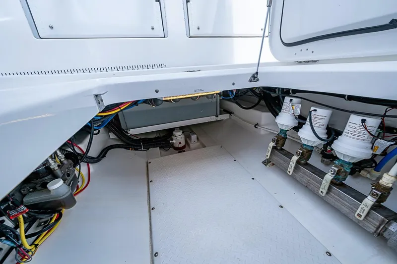 Slide: The Image of Engine compartment of a 2009 Everglades 350 Center Console boat, showcasing wiring and filters. - 22