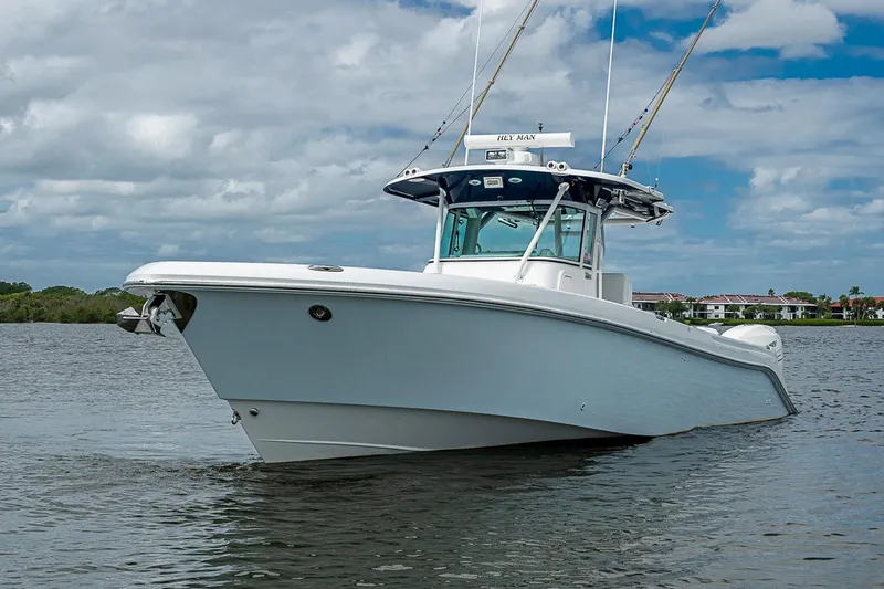 Slide: The Image of 2009 Everglades 350 Center Console boat on calm water under cloudy sky. - 24
