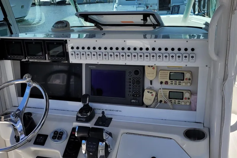 Slide: The Image of 2009 Everglades 350 Center Console boat with triple 400 horsepower engines on water. - 4