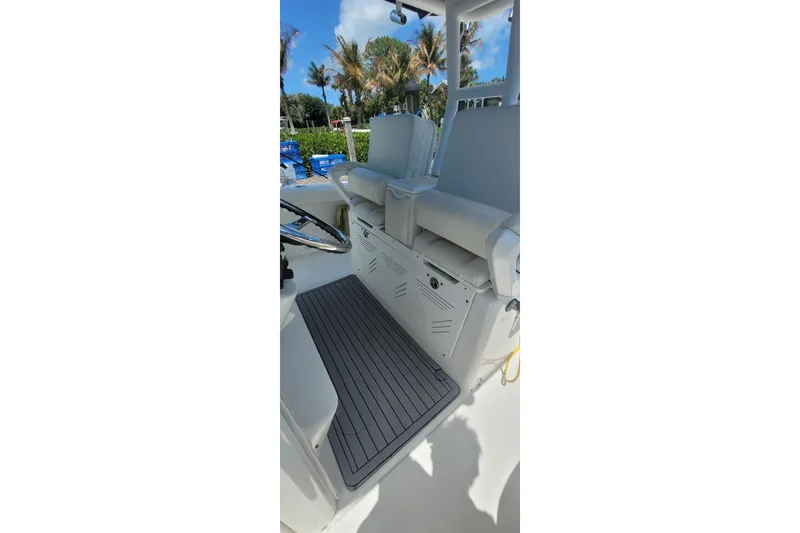 Slide: The Image of 2009 Everglades 350 Center Console boat on a scenic waterway under a partly cloudy sky. - 7