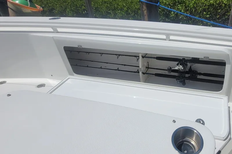 Slide: The Image of 2009 Everglades 350 Center Console boat interior with storage compartment open. - 8